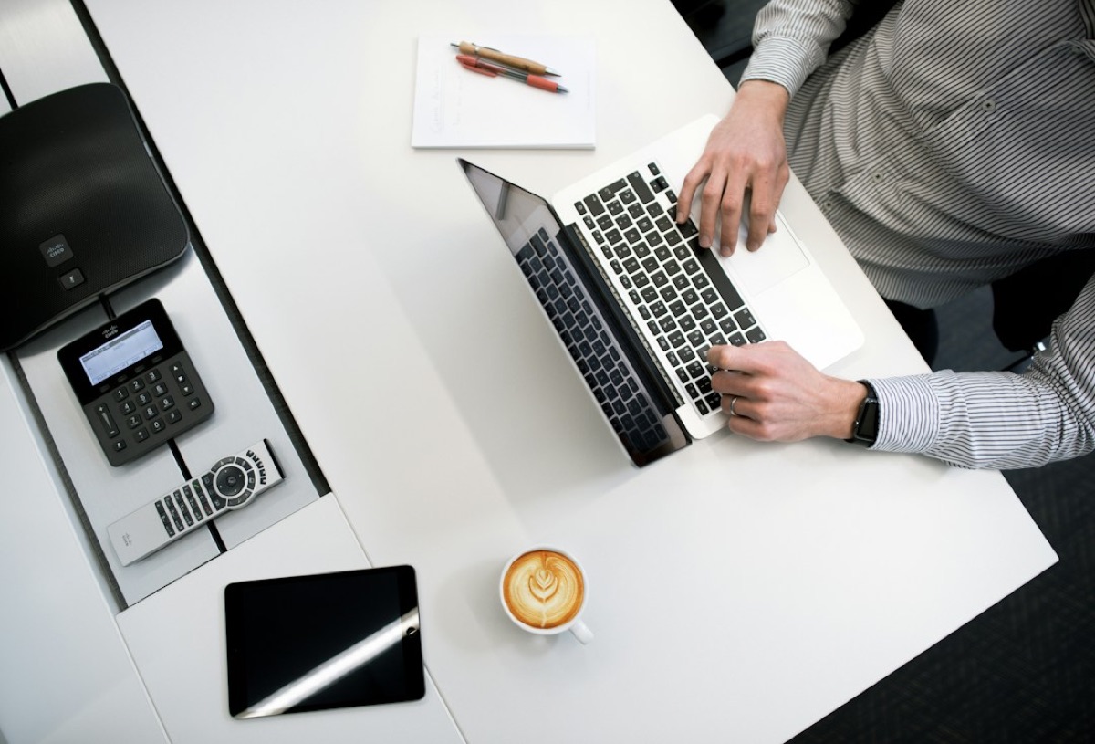Professional working on a laptop at a modern desk