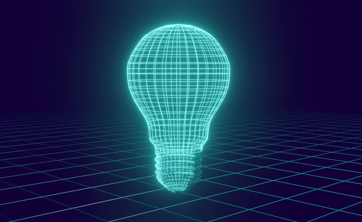 Glowing wireframe light bulb on a digital grid